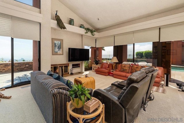 living room featuring high vaulted ceiling and light colored carpet