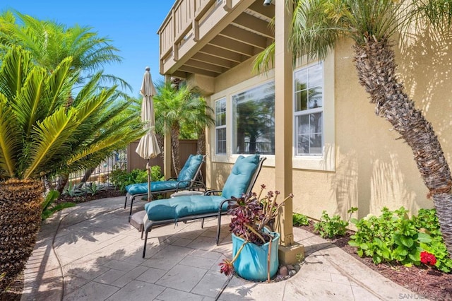 view of patio featuring a balcony