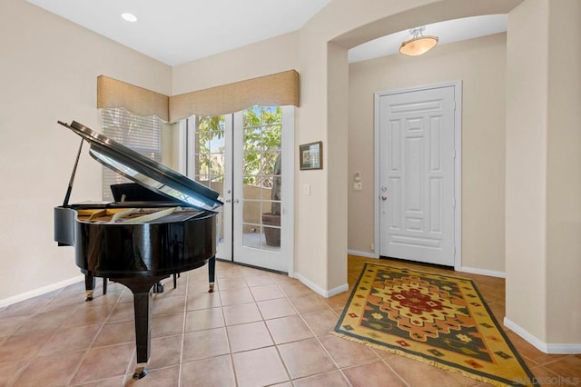 entryway with tile patterned flooring and french doors