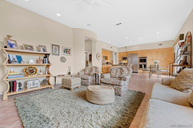 living room with ceiling fan and light tile patterned flooring