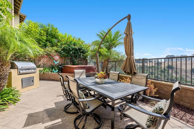 view of patio / terrace with a grill and a hot tub