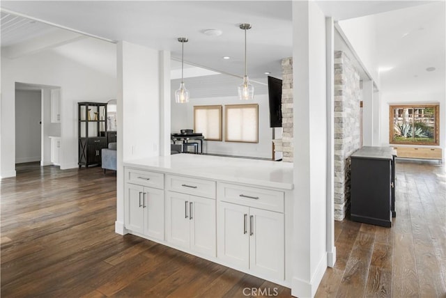 kitchen featuring pendant lighting, dark wood-type flooring, white cabinetry, and a healthy amount of sunlight