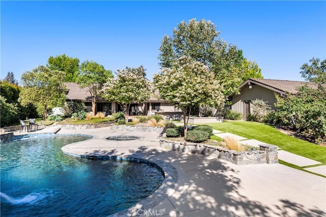 view of pool with a patio area and a yard