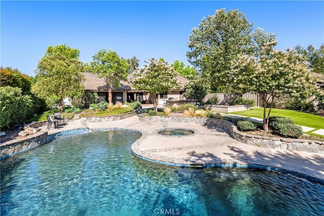 view of swimming pool with a water view and an in ground hot tub