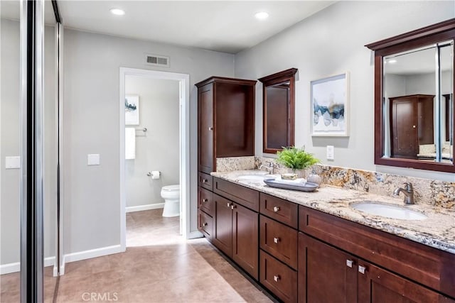 bathroom featuring tile patterned floors, vanity, and toilet