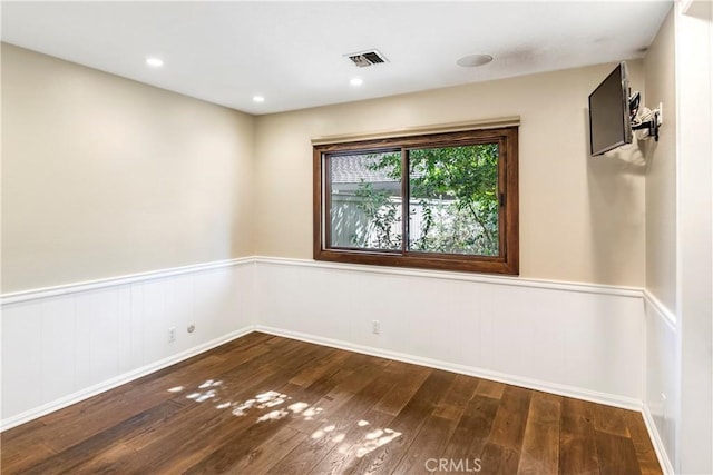 unfurnished room featuring dark hardwood / wood-style flooring