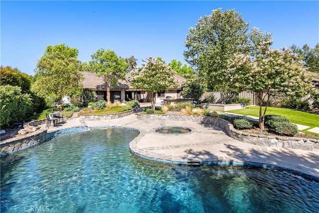 view of pool with an in ground hot tub