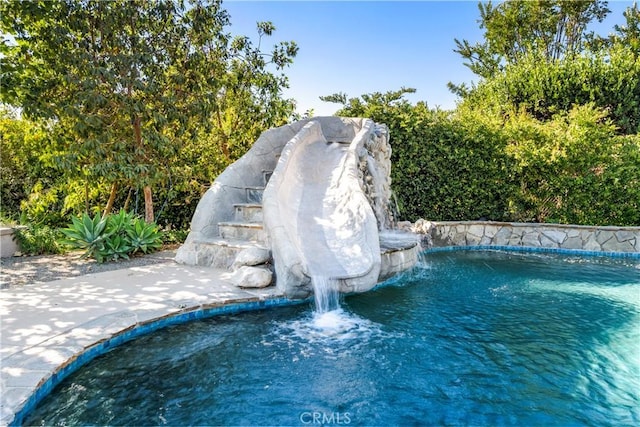 exterior space featuring pool water feature