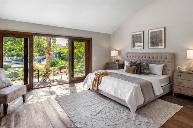 bedroom featuring lofted ceiling, dark wood-type flooring, and access to outside