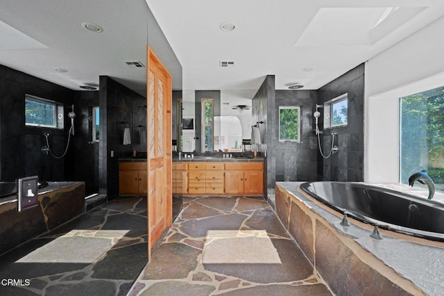 bathroom with vanity and independent shower and bath