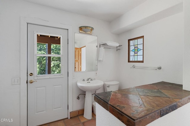 bathroom with tile patterned floors and toilet