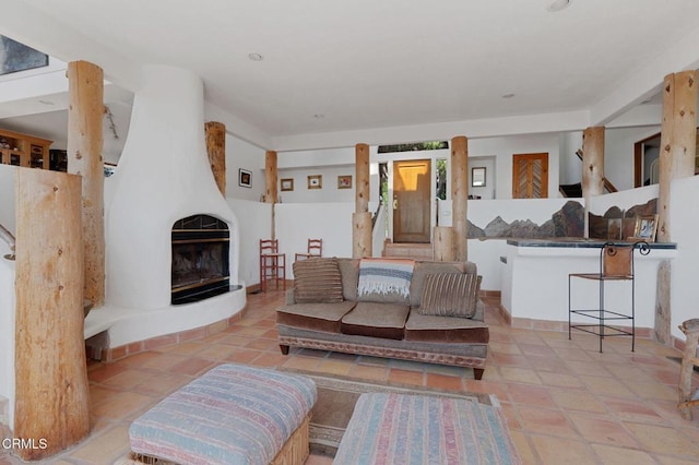 living room featuring a fireplace and light tile patterned floors