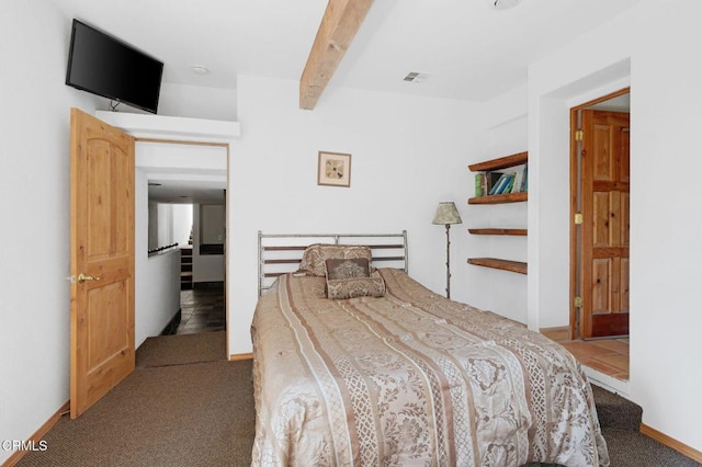 bedroom with beamed ceiling and carpet floors