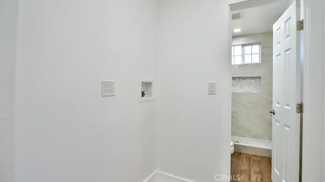 laundry room featuring washer hookup and hardwood / wood-style floors