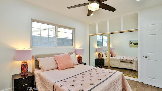 bedroom with ceiling fan, a closet, and light wood-type flooring