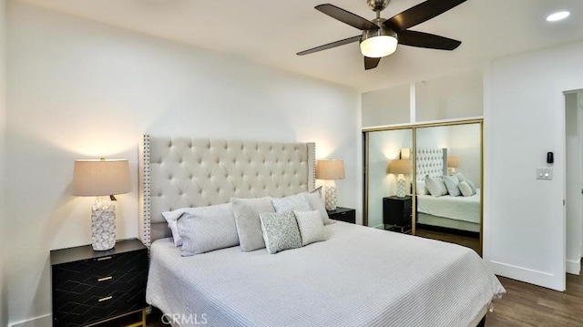 bedroom featuring a closet, ceiling fan, and dark hardwood / wood-style flooring