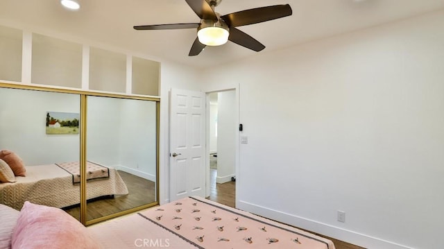 bedroom with ceiling fan, hardwood / wood-style flooring, and a closet