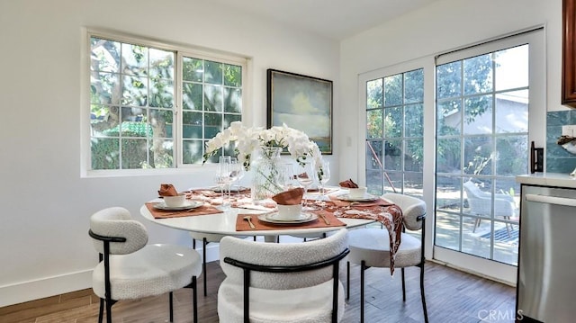 dining space with wood-type flooring