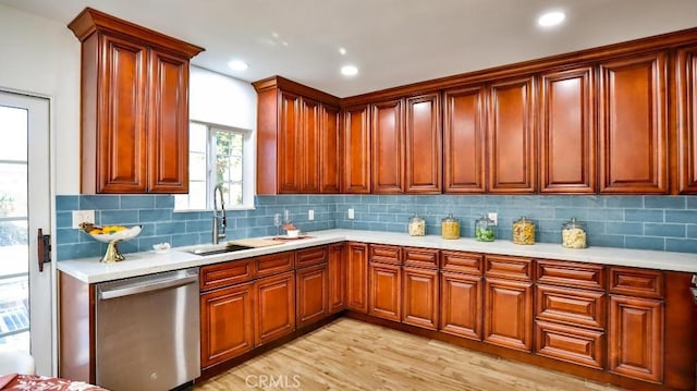 kitchen featuring sink, backsplash, light hardwood / wood-style flooring, and dishwasher