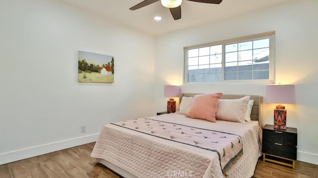 bedroom with wood-type flooring and ceiling fan