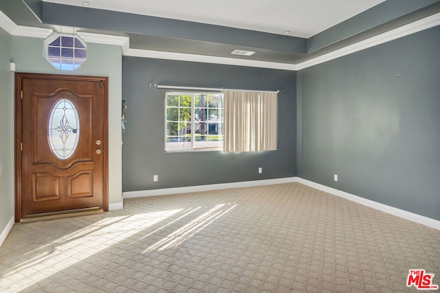 entryway featuring light colored carpet and ornamental molding