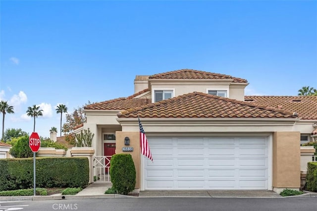 mediterranean / spanish-style house with a garage