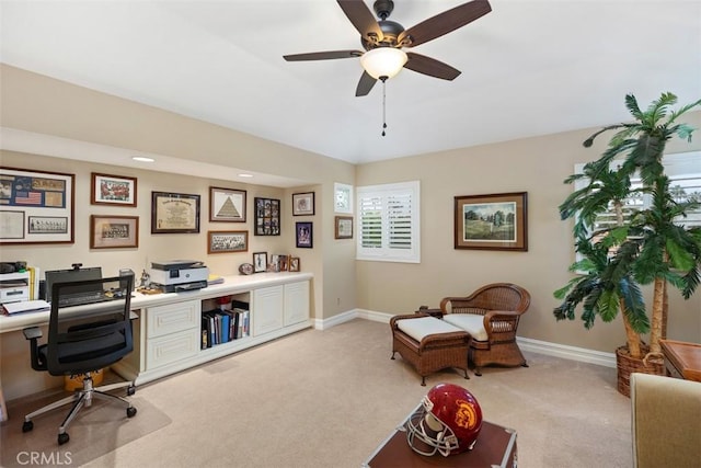 carpeted home office with ceiling fan