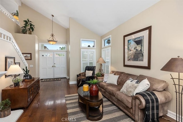 living room with high vaulted ceiling and dark hardwood / wood-style floors