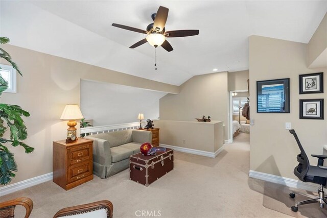 interior space featuring light colored carpet, a wealth of natural light, lofted ceiling, and ceiling fan