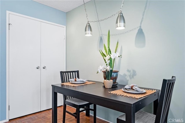 dining room with a textured ceiling and parquet floors