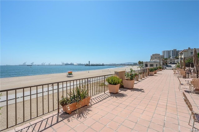 view of patio featuring a water view and a view of the beach