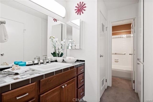 bathroom featuring vanity and washtub / shower combination