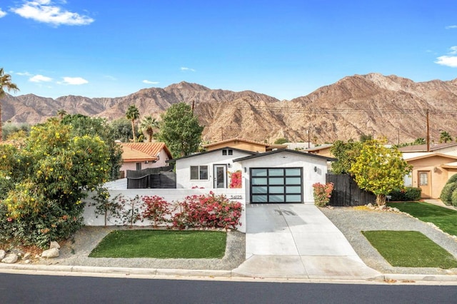 view of front of house with a garage and a mountain view