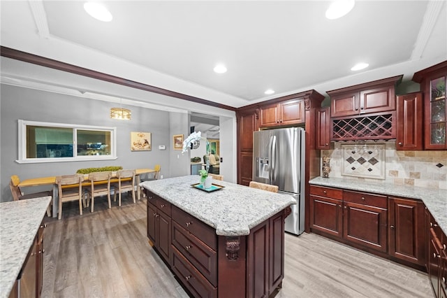 41026 Los Amantes Rd, Temecula, CA 92592 - kitchen with stainless steel fridge, light wood-style flooring, decorative backsplash, recessed lighting, and light stone counters