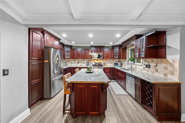 41026 Los Amantes Rd, Temecula, CA 92592 - kitchen featuring appliances with stainless steel finishes, light wood finished floors, dark brown cabinets, decorative backsplash, and a textured wall