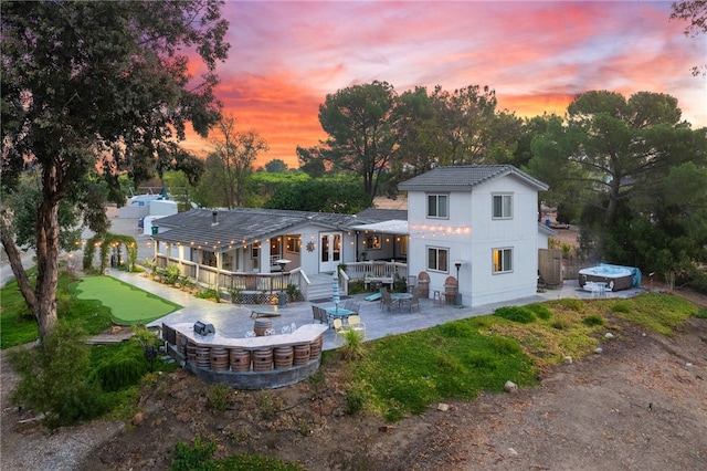 41026 Los Amantes Rd, Temecula, CA 92592 - rear view of property with a jacuzzi, a patio, a putting area, and a deck