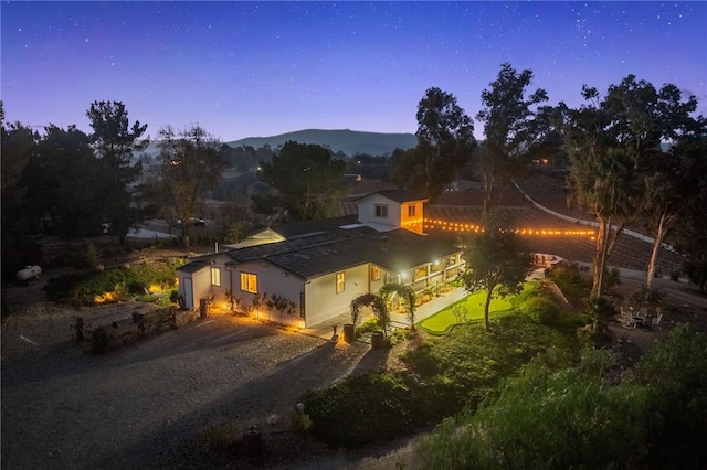 41026 Los Amantes Rd, Temecula, CA 92592 - view of front facade featuring dirt driveway, a garage, and a mountain view