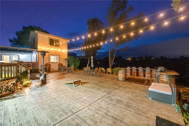 41026 Los Amantes Rd, Temecula, CA 92592 - patio at night featuring a wooden deck and outdoor dining space