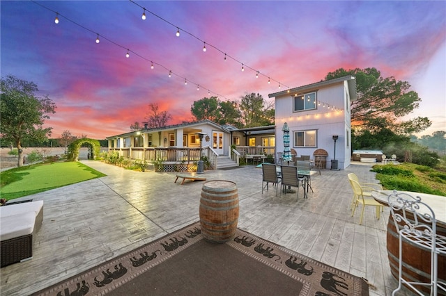 41026 Los Amantes Rd, Temecula, CA 92592 - back of house at dusk featuring a patio, outdoor dining space, and a deck