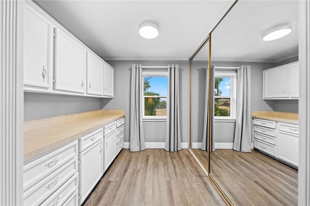 41026 Los Amantes Rd, Temecula, CA 92592 - kitchen featuring ornamental molding, light wood-style flooring, white cabinetry, and light countertops