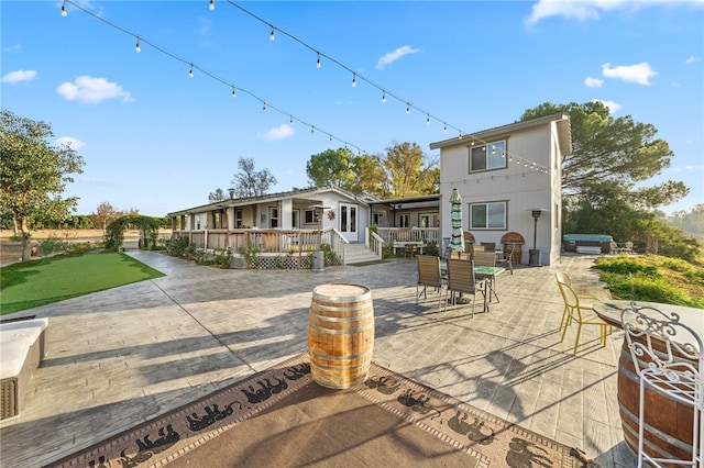 41026 Los Amantes Rd, Temecula, CA 92592 - back of property with a patio area, outdoor dining area, and a jacuzzi