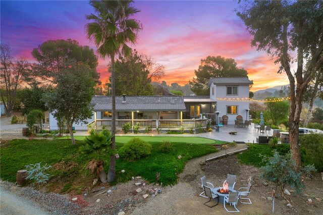 41026 Los Amantes Rd, Temecula, CA 92592 - back of property with a fire pit, a wooden deck, and a patio area