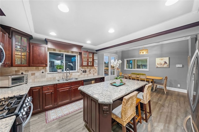 41026 Los Amantes Rd, Temecula, CA 92592 - kitchen with tasteful backsplash, appliances with stainless steel finishes, a kitchen bar, recessed lighting, and a kitchen island