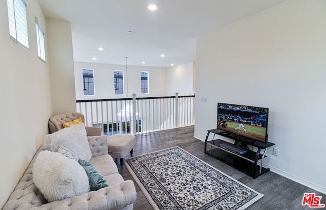 living room featuring dark hardwood / wood-style flooring and a wealth of natural light