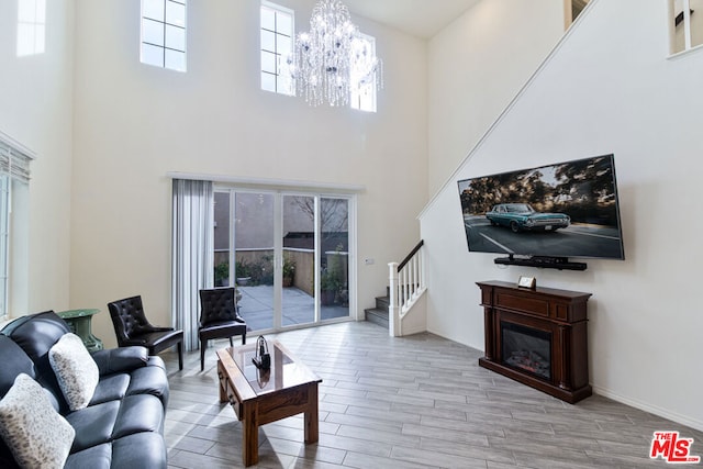 living room with a towering ceiling and a notable chandelier