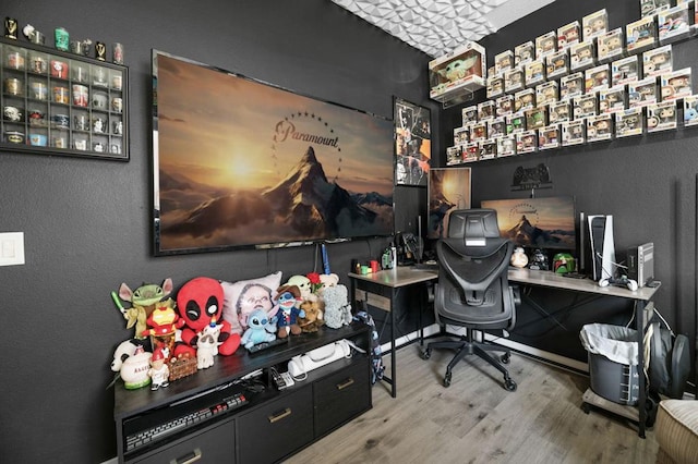 home office with wood-type flooring