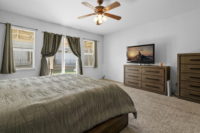 carpeted bedroom with access to exterior and ceiling fan