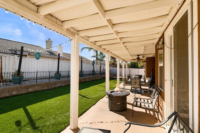 view of patio featuring ceiling fan and an outdoor fire pit