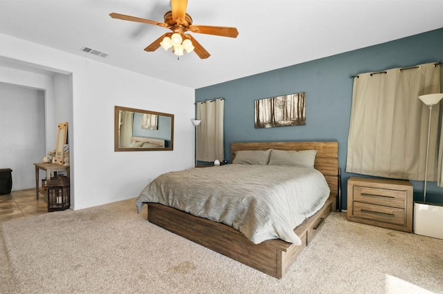 bedroom featuring ceiling fan and light carpet