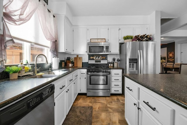 kitchen with white cabinets, appliances with stainless steel finishes, and sink